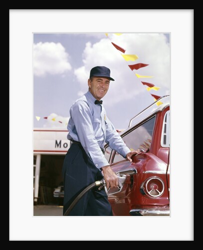 1950s smiling service station attendant pumping gas by Anonymous
