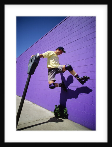 Boy Wearing Roller Blades Jumping Against Wall by Anonymous