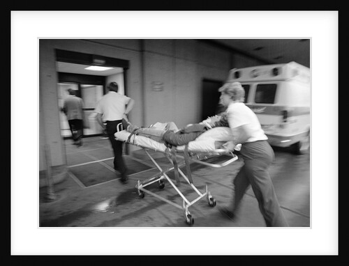 1980s EMT team rushing patient into a hospital on a stretcher by Anonymous