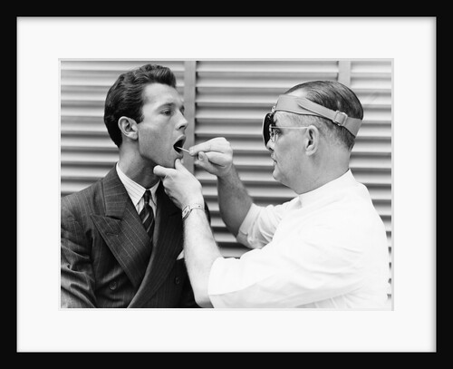 1930s 1940s doctor examining throat of a young man by Anonymous