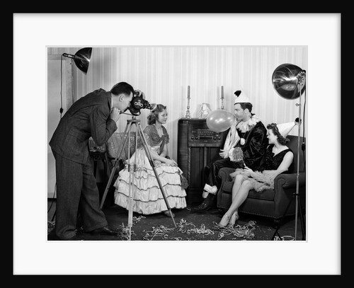 1940s photographer taking picture of young people at New Years party by Anonymous