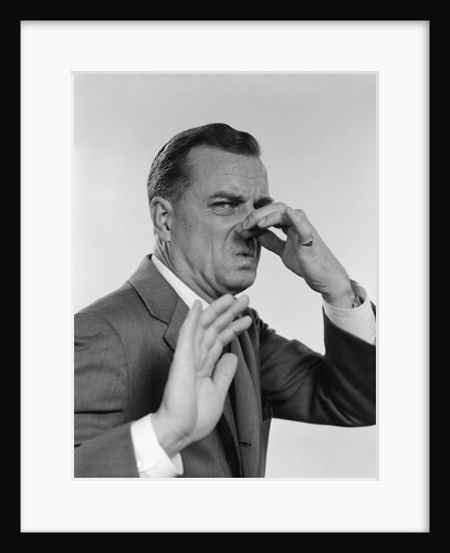 1950s 1960s man holding his nose by Anonymous