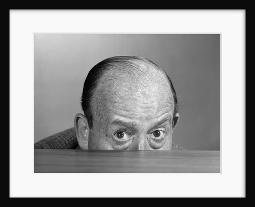 1960s balding man peeking over desktop by Anonymous