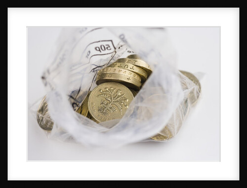 Looking down into an open money bag of pound coins by Anonymous