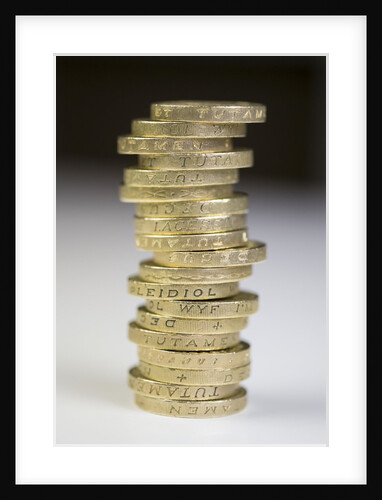 A pile of pound coins on a table by Anonymous