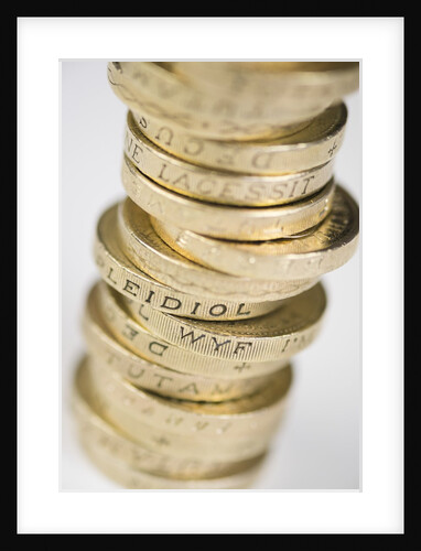 A pile of pound coins on a table by Anonymous