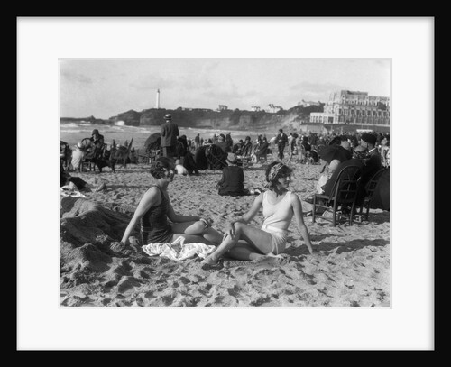 1920s two women sitting on the beach in bathing suits by Anonymous