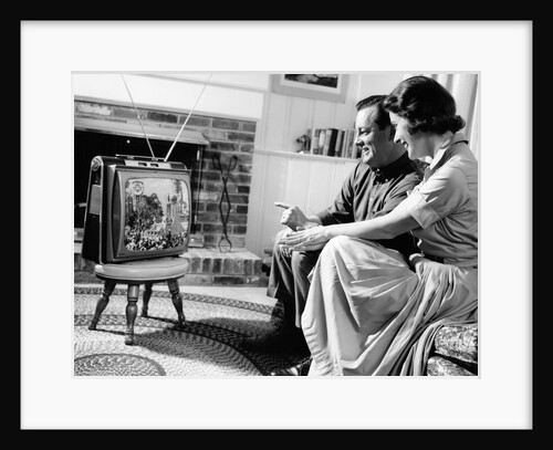 1950s couple watching television by Anonymous