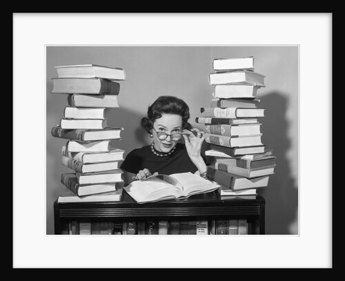 1950s portrait of woman sitting with stacks of books by Anonymous