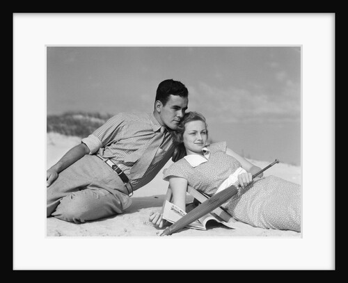 1930s couple lying on a beach by Anonymous