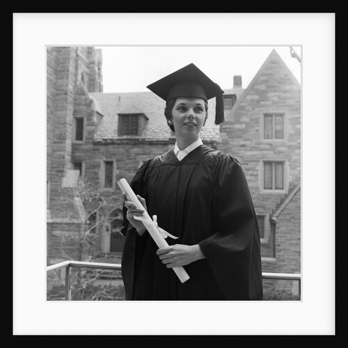 1950s smiling female graduate holding a diploma by Anonymous