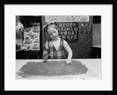 1980s girl with braids finger painting inside a classroom by Anonymous
