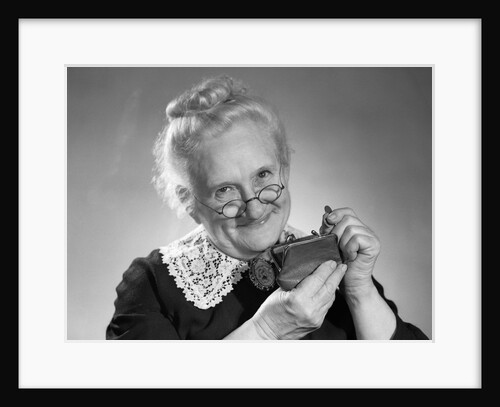 1950s portrait of senior woman putting change into a purse by Anonymous