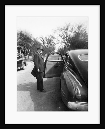 Mature man open his car door, ca. 1940. by Anonymous