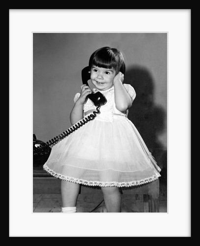 Young girl talks on the phone, ca. 1962. by Anonymous