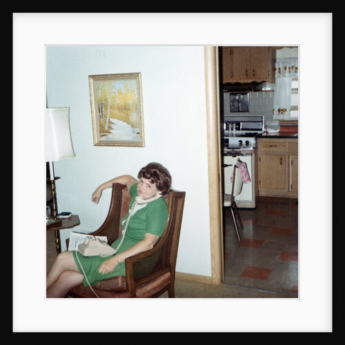 Mature woman on phone in her home, ca. 1970. by Anonymous