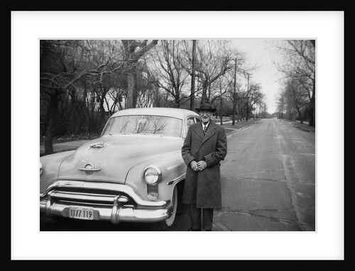 Senior man with his automobile on an Illinois street, ca. 1950. by Anonymous