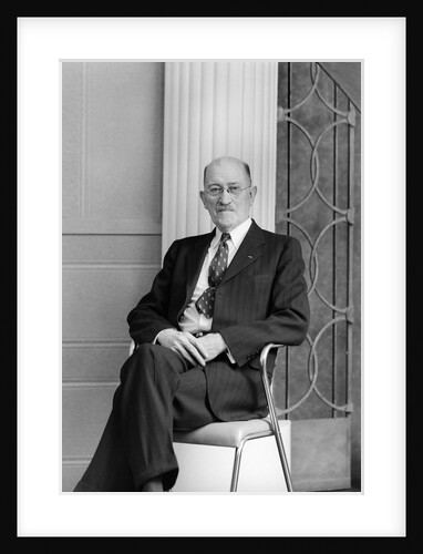 Senior man sits for a portrait in a chair, ca. 1948. by Anonymous