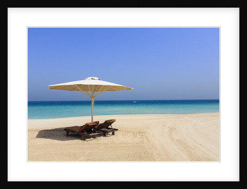 Parasol and recliner on the beach, Dubai by Anonymous