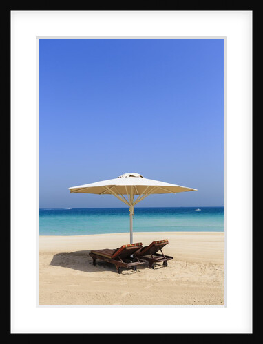 Parasol and recliner on the beach, Dubai by Anonymous