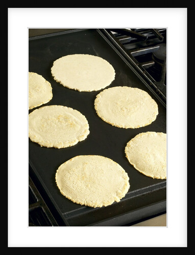 Cooking corn tortillas by Anonymous
