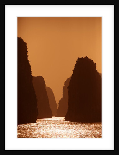 Karst formations at sunset in Bai Tu Long Bay in Halong Bay UNESCO World Heritage Site, Vietnam by Anonymous