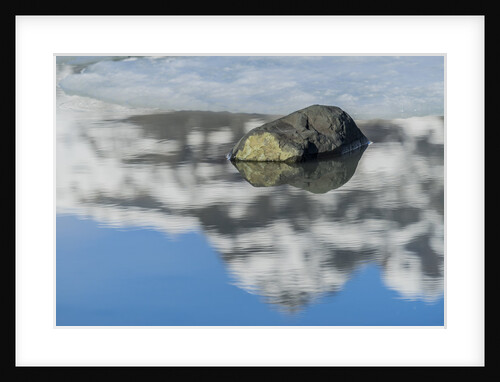 Rock with sky reflected in water. by Anonymous