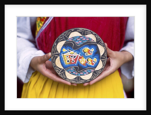 Woman holding wooden plate, China by Anonymous