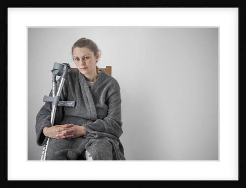 Woman seated with crutches by Anonymous