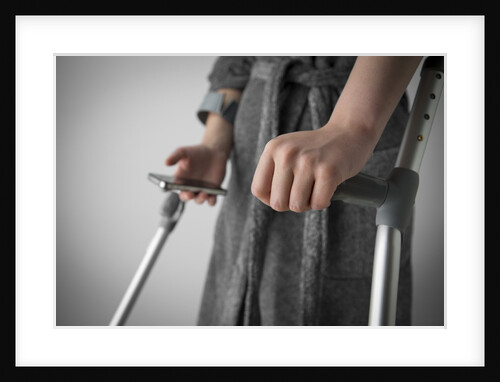 Person on crutches texting by Anonymous