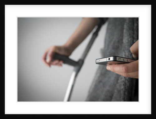 Person on crutches texting by Anonymous