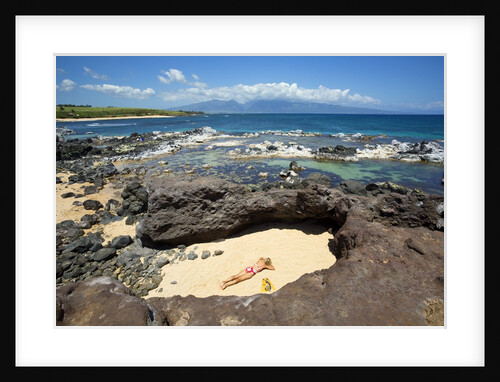 Woman sunbathing in secluded area of sand, Ho'okipa Beach Park, Maui, Hawaii MR by Anonymous
