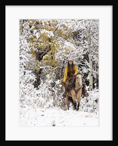 Cowgirl riding in Autumn Aspens with a fresh snowfall by Anonymous