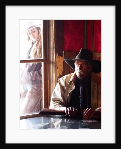 Cowboy with rifle and Cowgirl looking over his shoulder by Anonymous