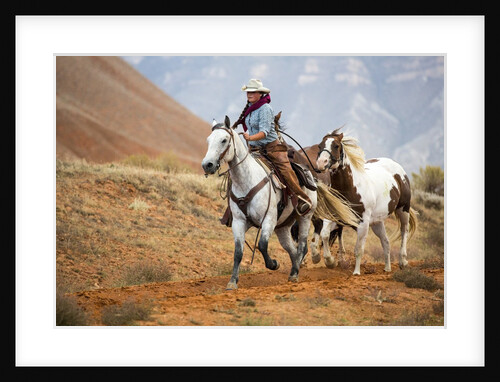 Cowgirl at Full Gallop with Horses in tow by Anonymous