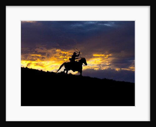 Cowboy in silhouette with sunset by Anonymous
