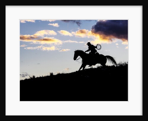 Cowboy in silhouette with sunset by Anonymous