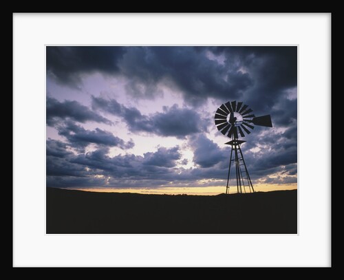 Windmill Silhouette Under Broken Clouds by Anonymous