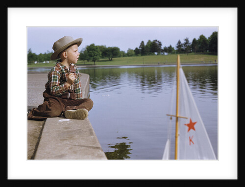 Boy Sitting by Lake in Cowboy Hat by Anonymous
