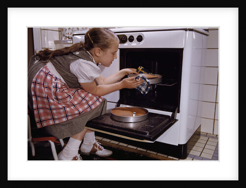 Girl Wearing Apron Removing Cakes from Oven by Anonymous