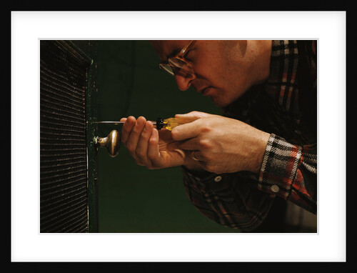 Man Fixing Knob on Screen Door by Anonymous