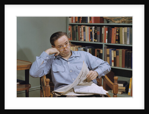 Man Holding Newspaper While Thinking by Anonymous