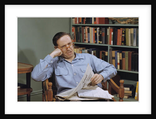 Man Holding Newspaper While Thinking by Anonymous