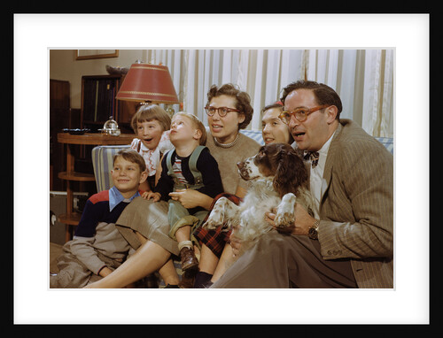 Family Sitting on Couch Together by Anonymous
