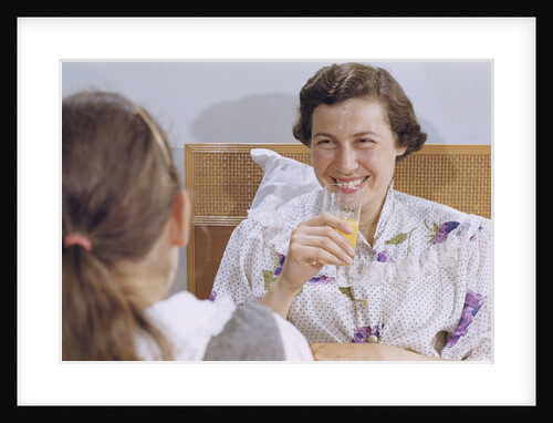 Mother Enjoying Glass of Orange Juice in Bed by Anonymous