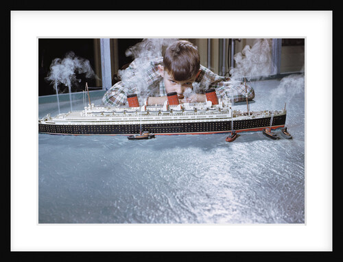 Boy Playing with Toy Ocean Liner by Anonymous