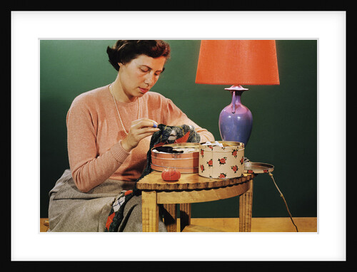Woman Darning Socks by Anonymous