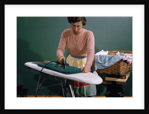 Woman Ironing at Home by Anonymous