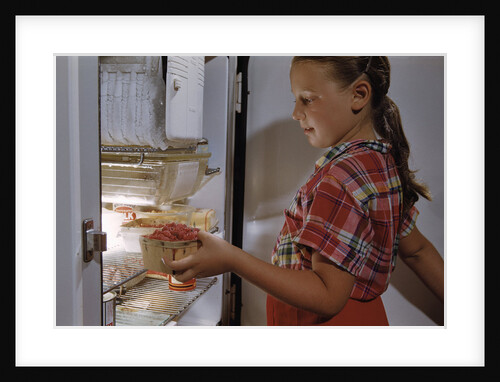 Girl Removing Raspberries from Freezer by Anonymous