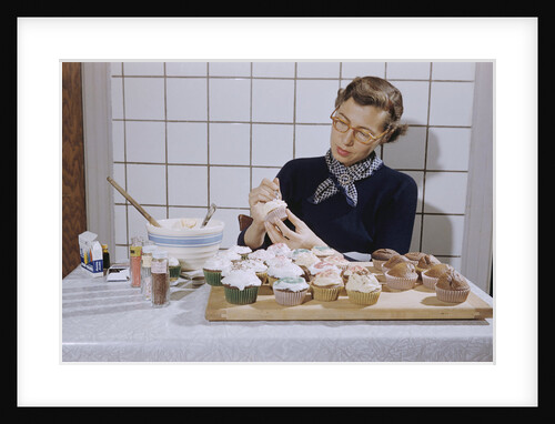 Woman Decorating Cup Cakes by Anonymous
